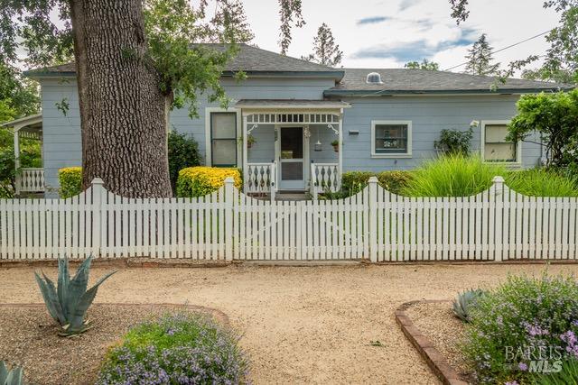 a front view of a house with a fence