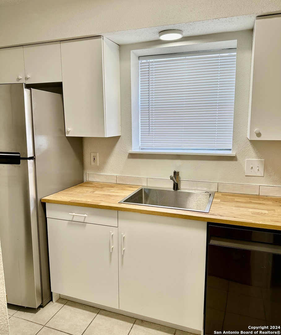 a kitchen with a sink and a refrigerator