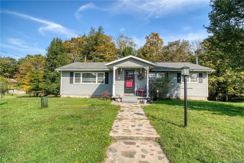 Single story home featuring a front lawn