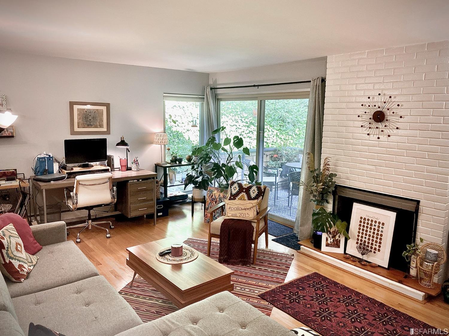 a living room with furniture a rug and a fireplace