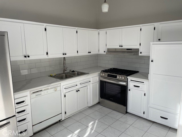 a kitchen with white cabinets and white appliances