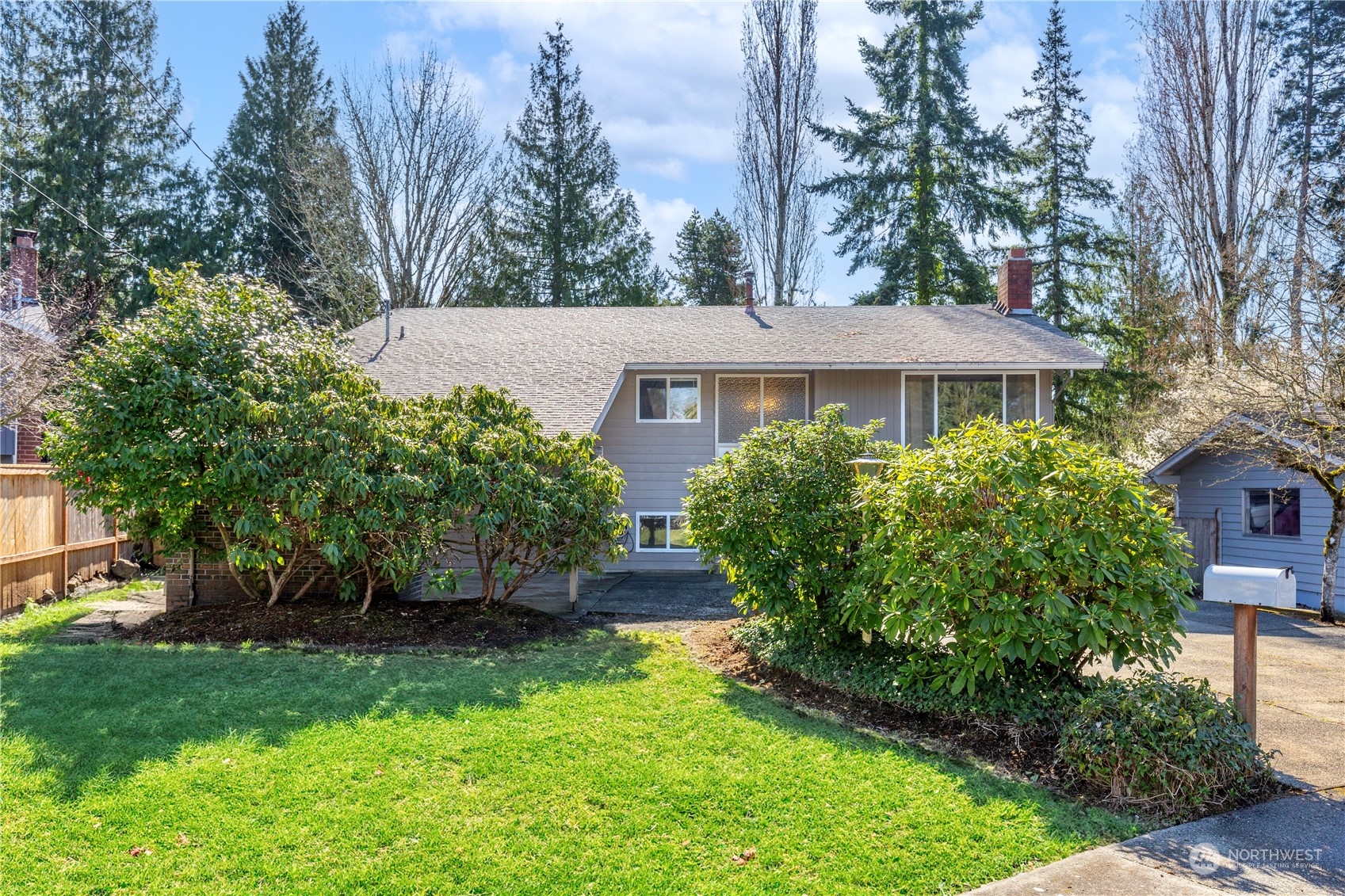 a view of a house with a yard and plants