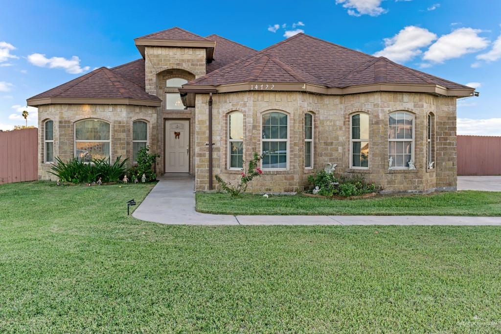 a front view of a house with a yard