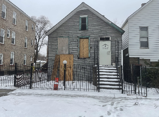 a front view of a house with iron fence