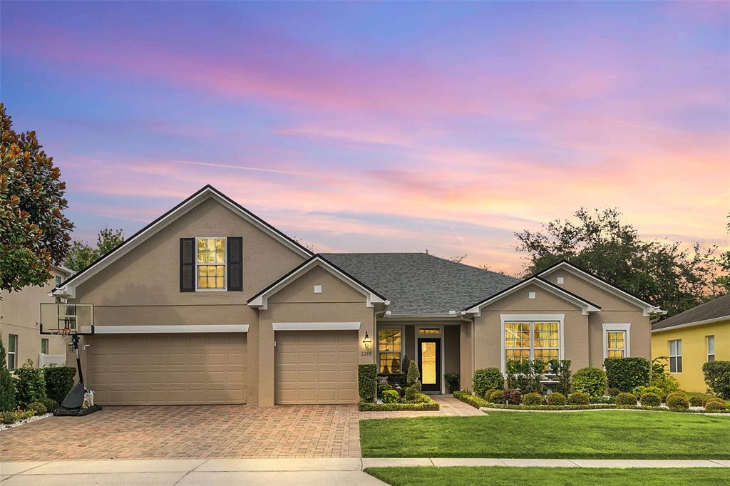 a front view of a house with a yard and garage