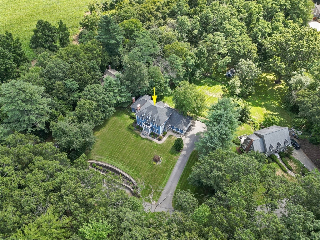 an aerial view of a house with a yard basket ball court and outdoor seating