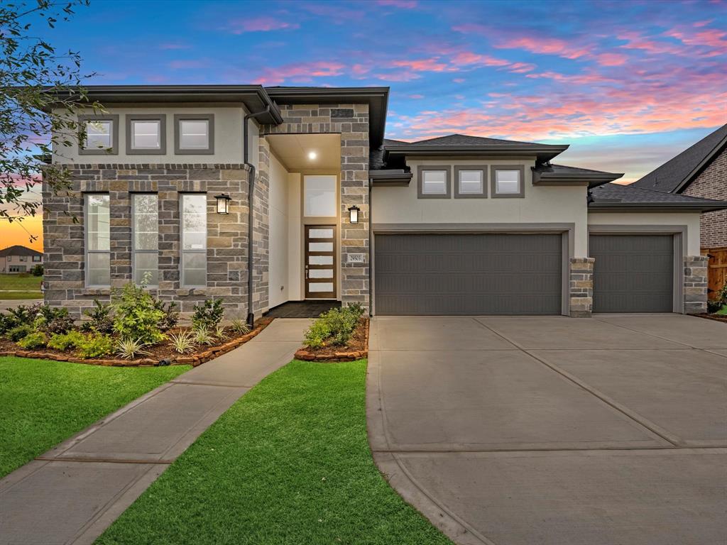 a front view of a house with a garden and yard