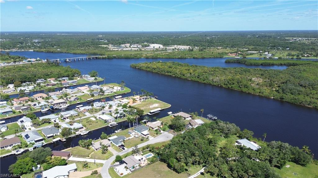 an aerial view of a residential houses with outdoor space and river