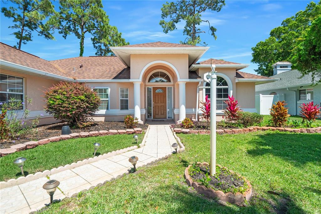 a front view of a house with garden