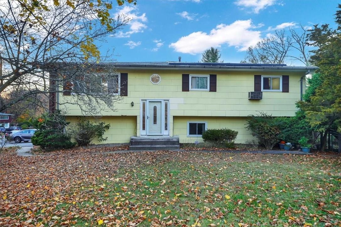 Split foyer home featuring a front lawn