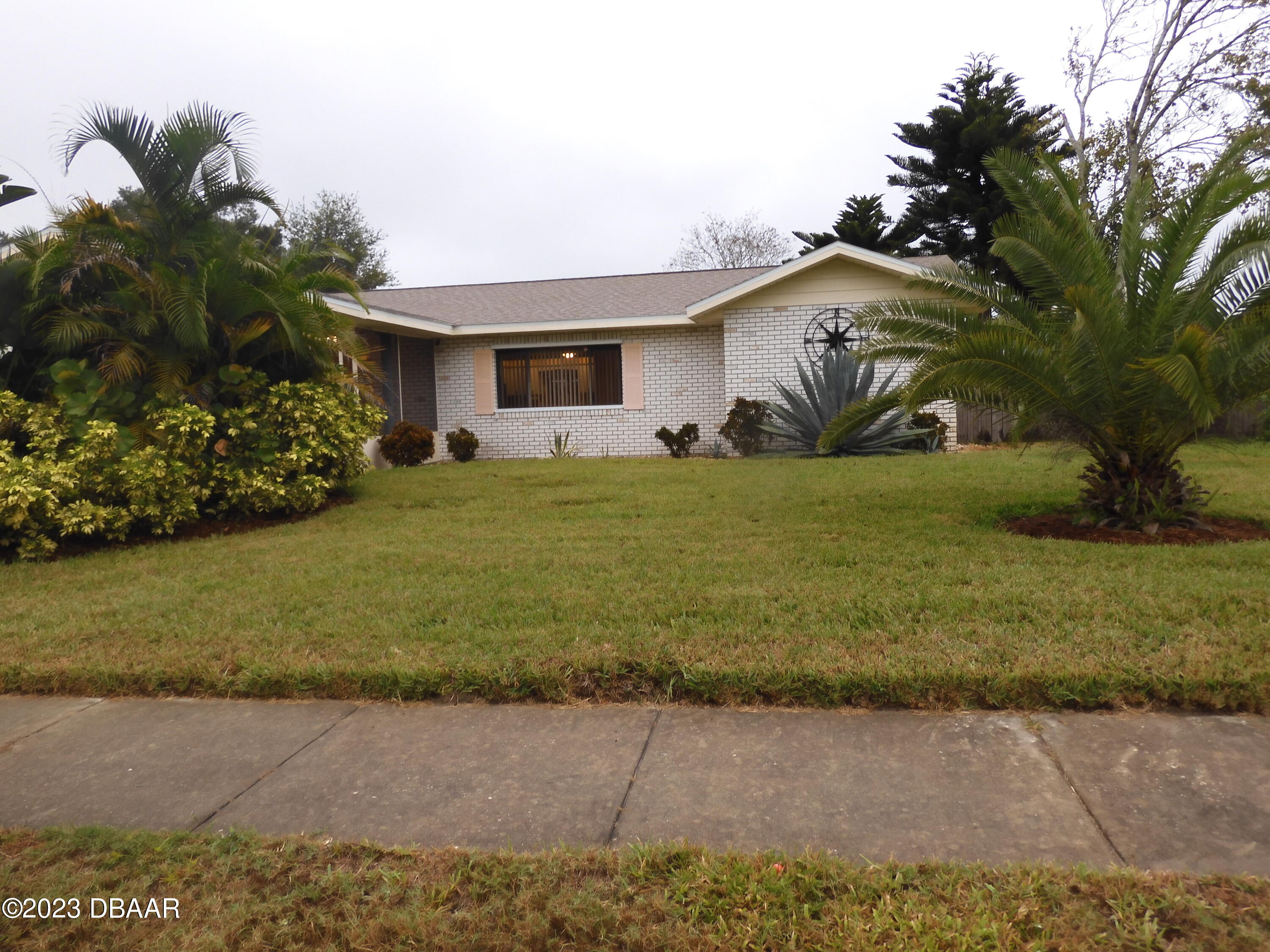 a front view of a house with a garden