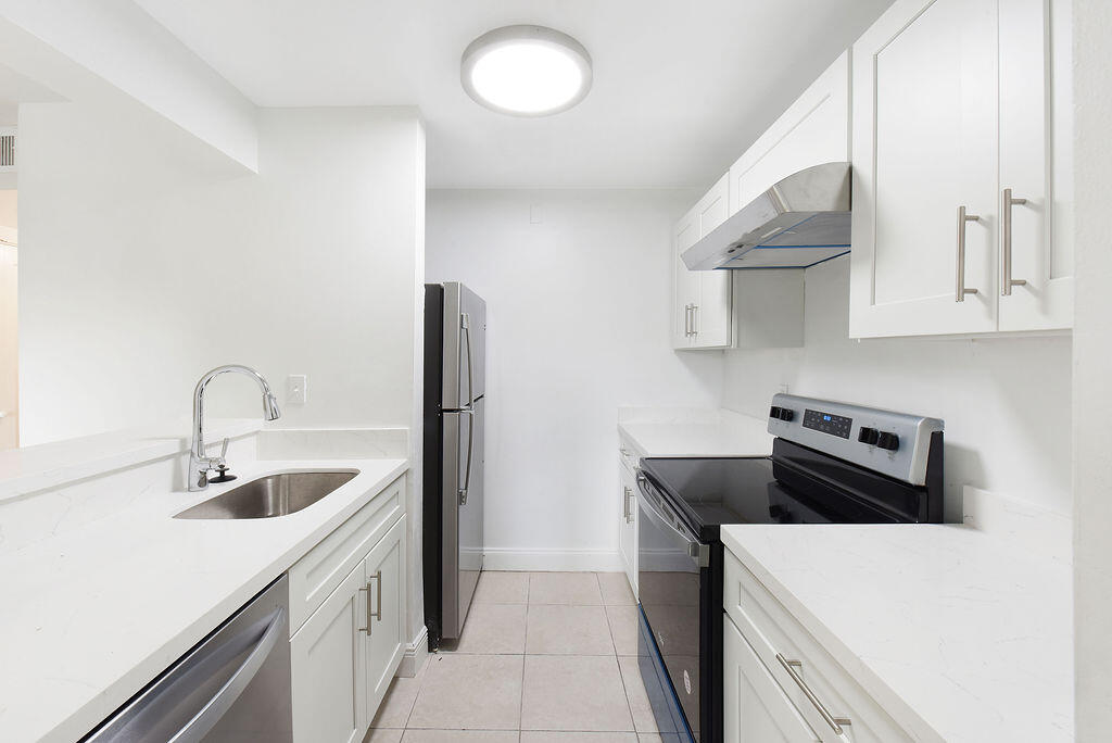 a kitchen that has a sink and a stove