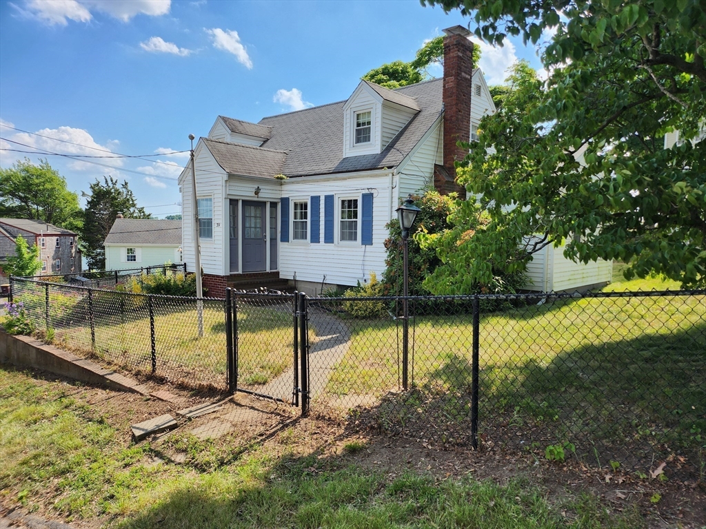 a view of house with a yard and swimming pool