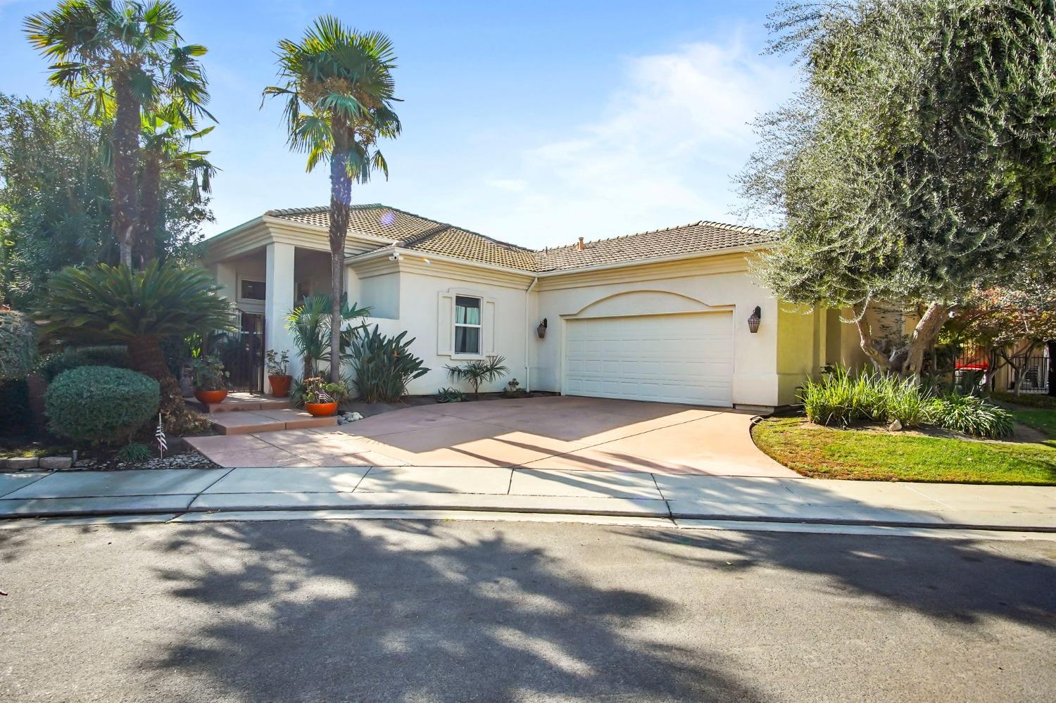 a front view of a house with a garden and patio