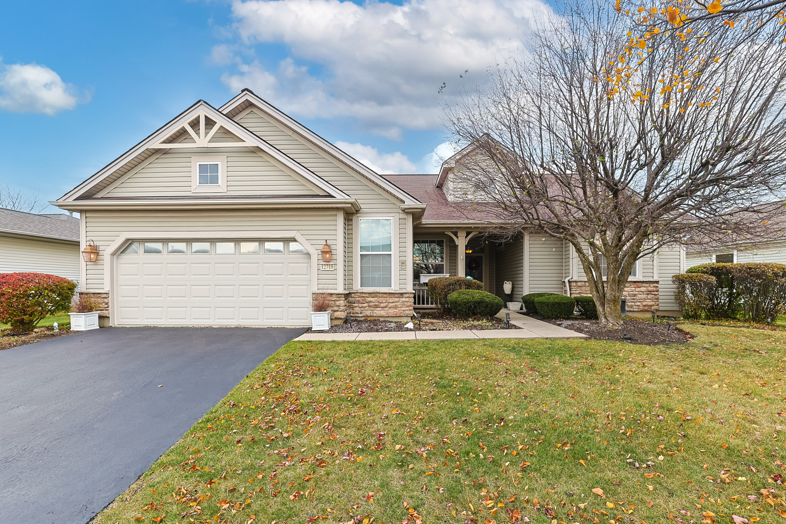 a front view of a house with a yard and garage