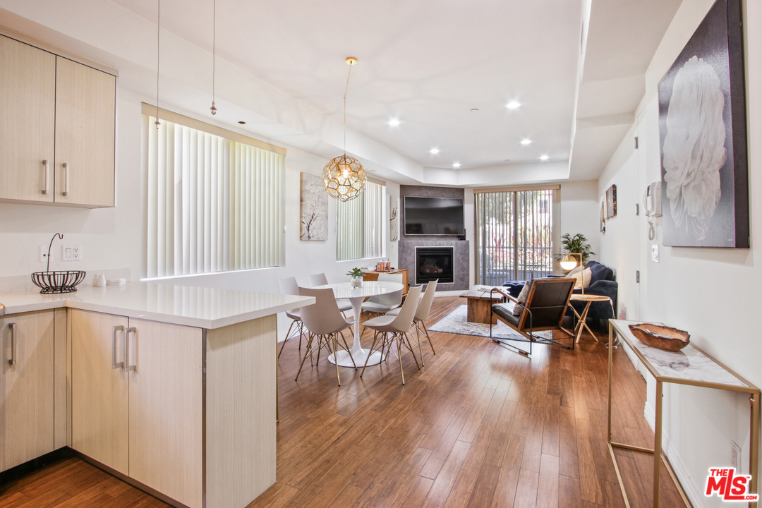 a living room with furniture a wooden floor and a sink