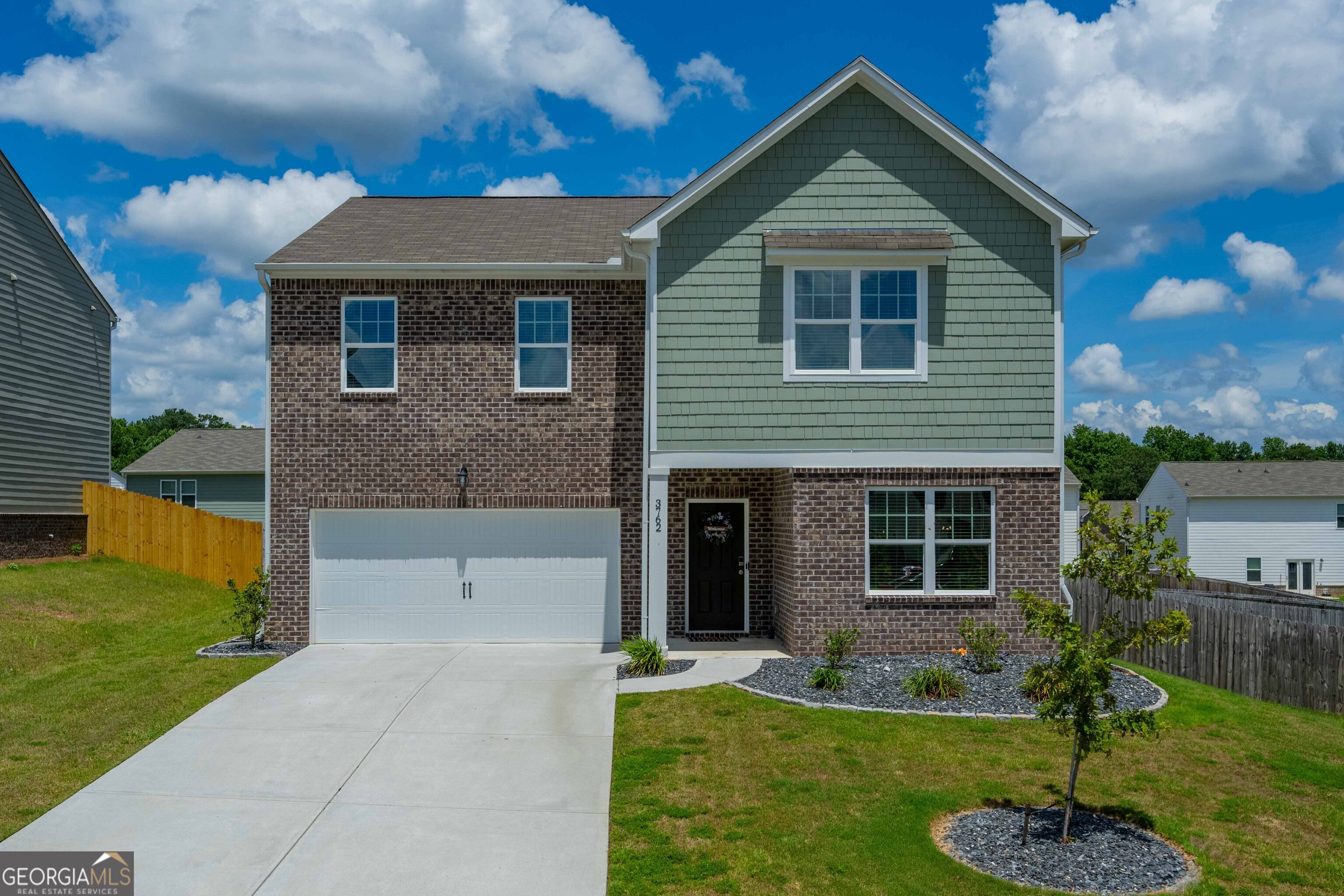 a front view of a house with a yard