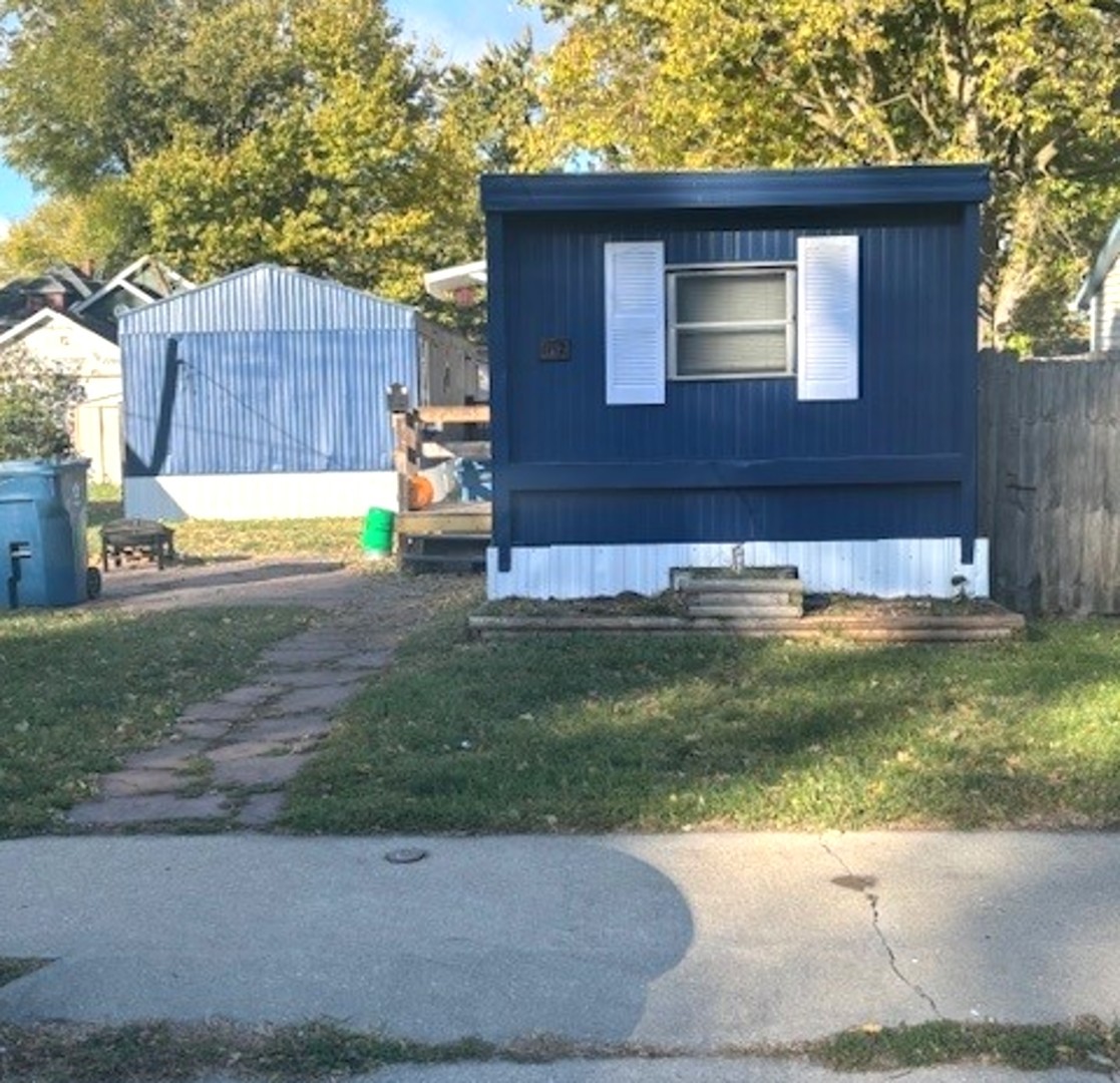 a view of a backyard with a small cabin