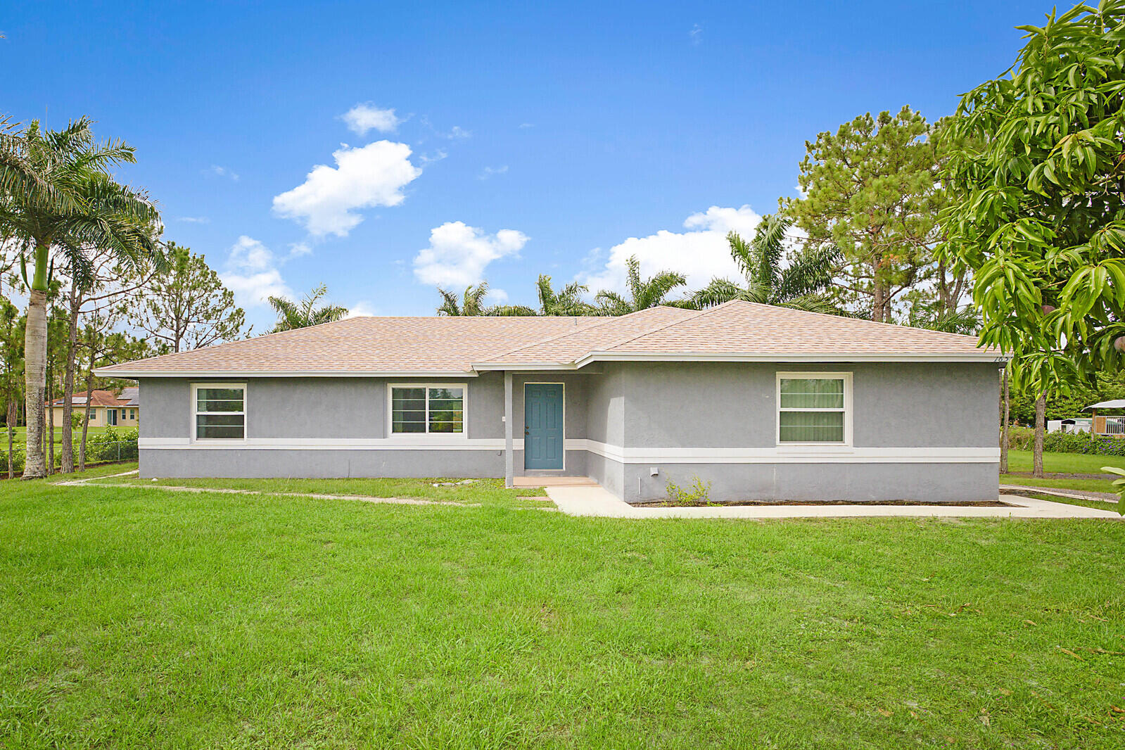 a front view of house with yard and green space