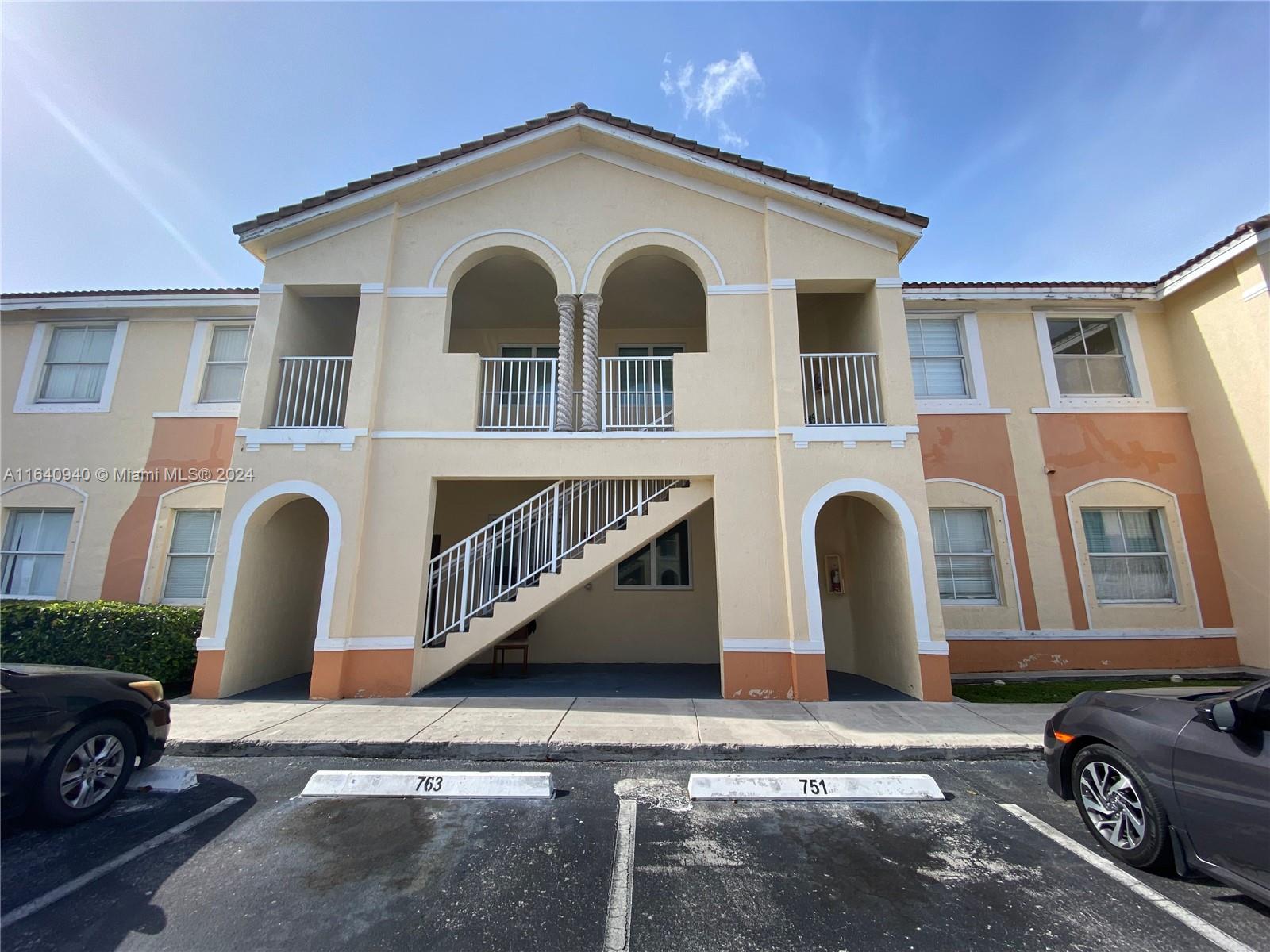 a front view of a house with parking space