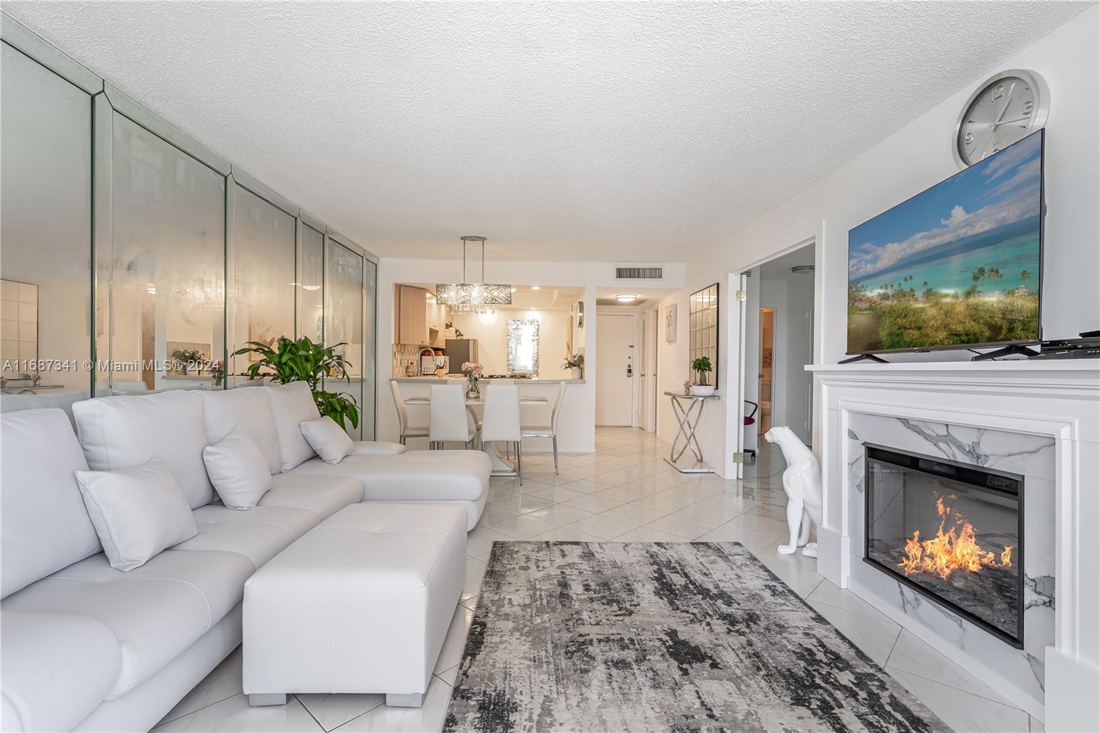 a living room with furniture fireplace and flat screen tv