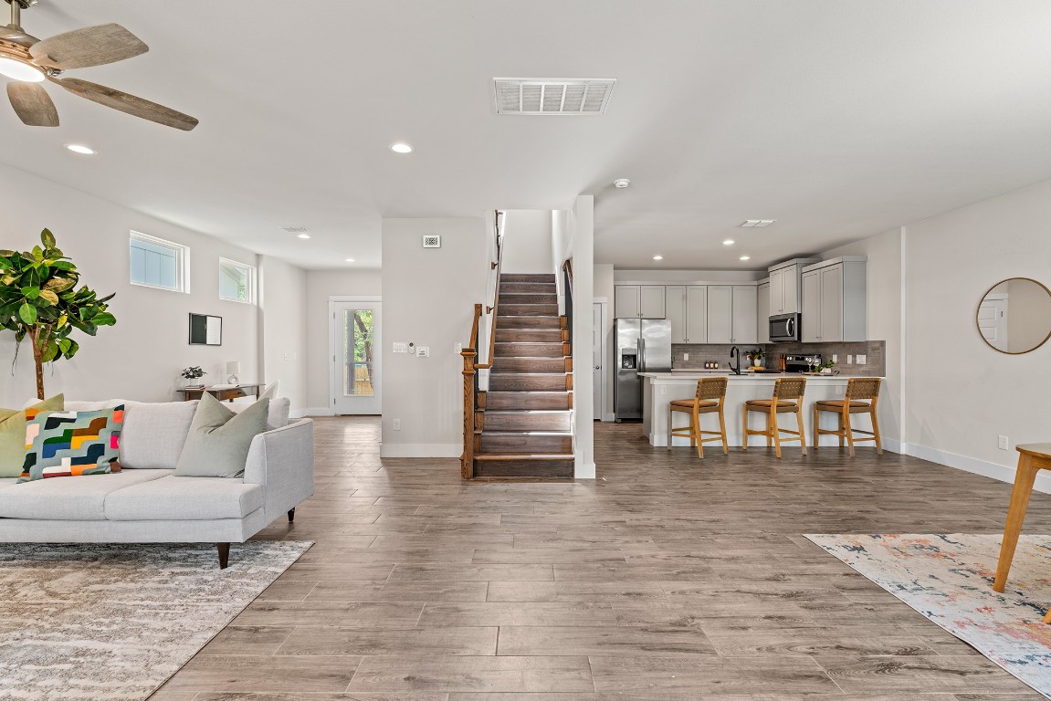 a living room with furniture and wooden floor