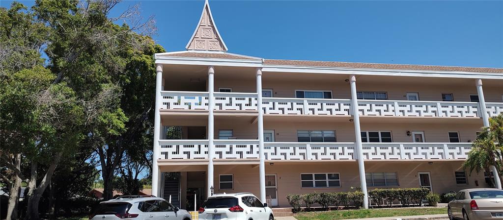 a front view of a building with parking space and a parking space