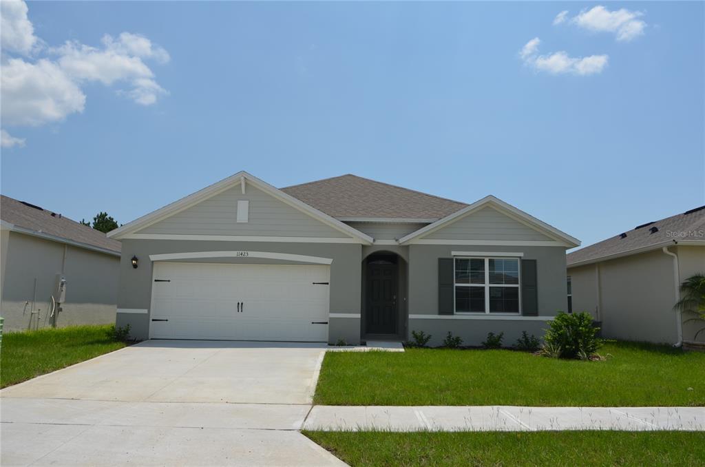 a front view of a house with a yard and garage