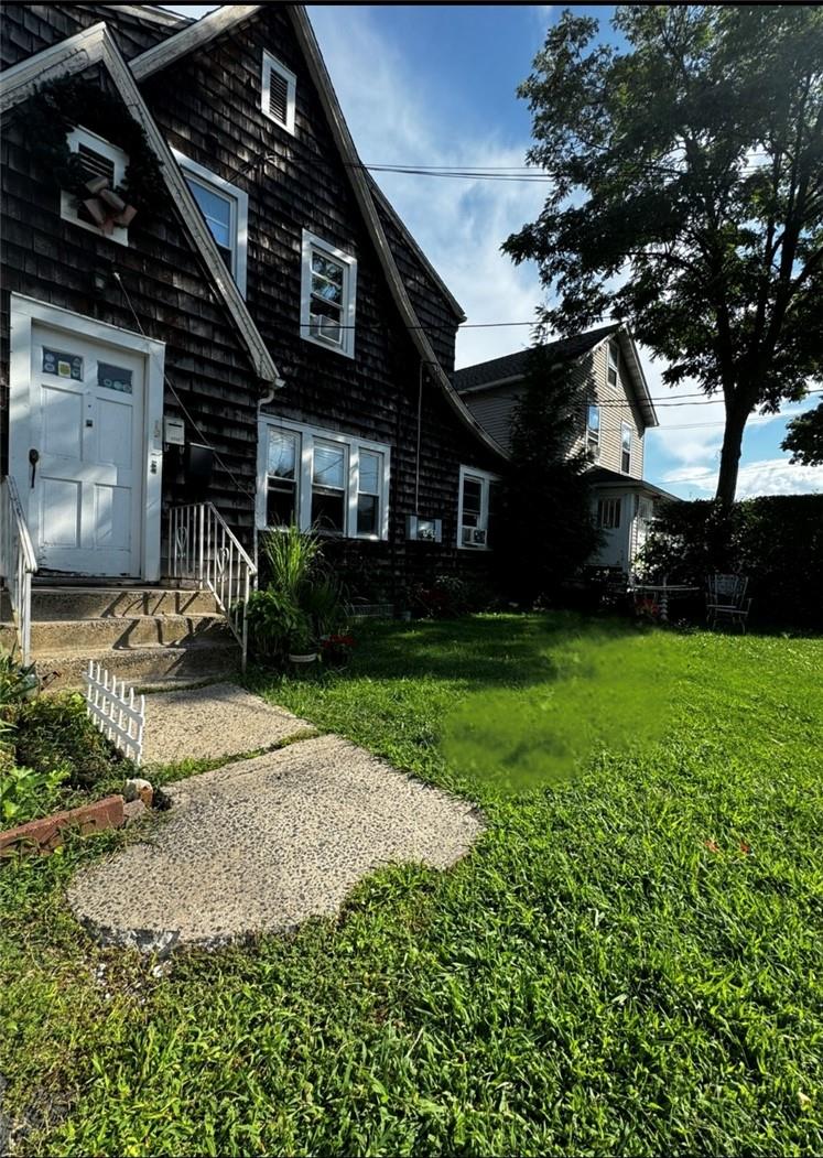 a front view of a house with garden