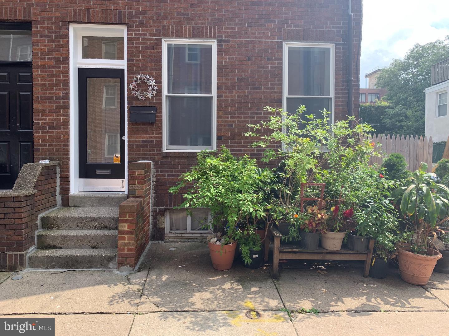 a potted plant sitting in front of a house