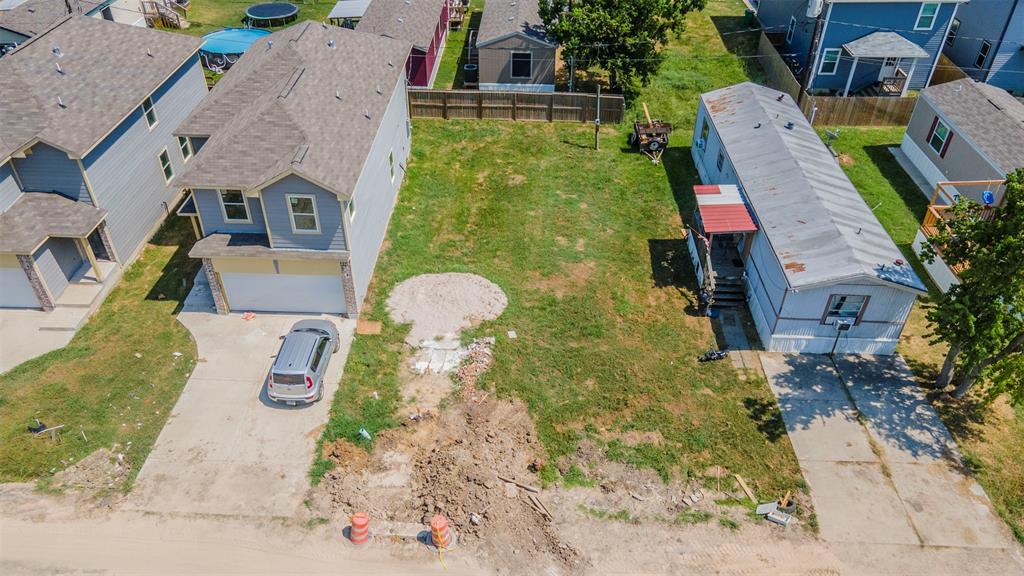 an aerial view of a house with garden space and street view