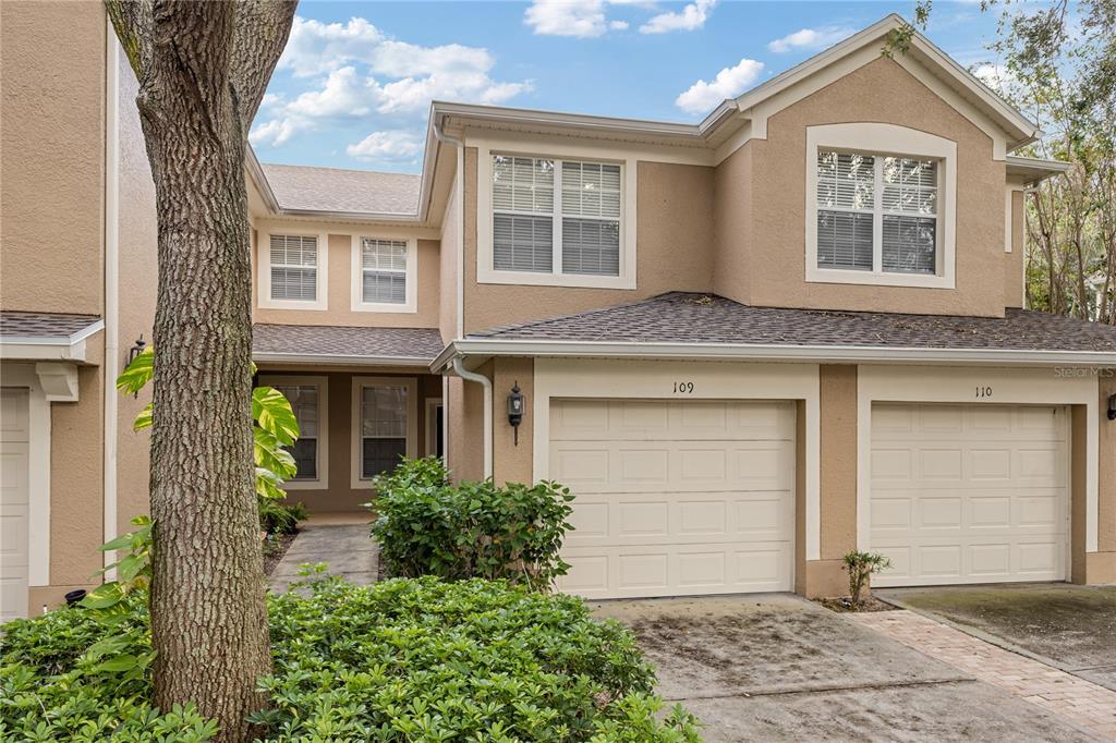 a front view of a house with a yard and garage