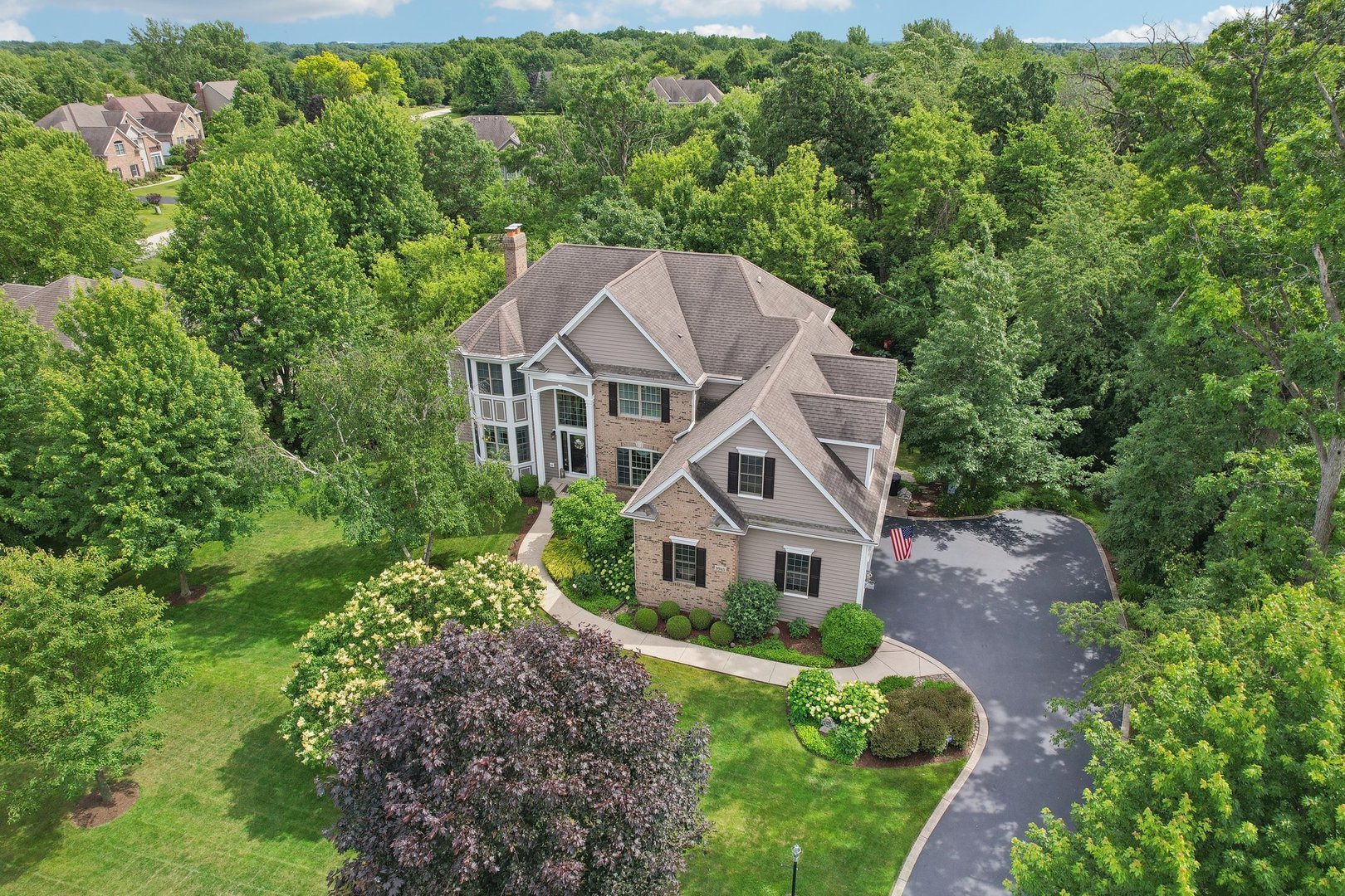 a aerial view of a house next to a yard