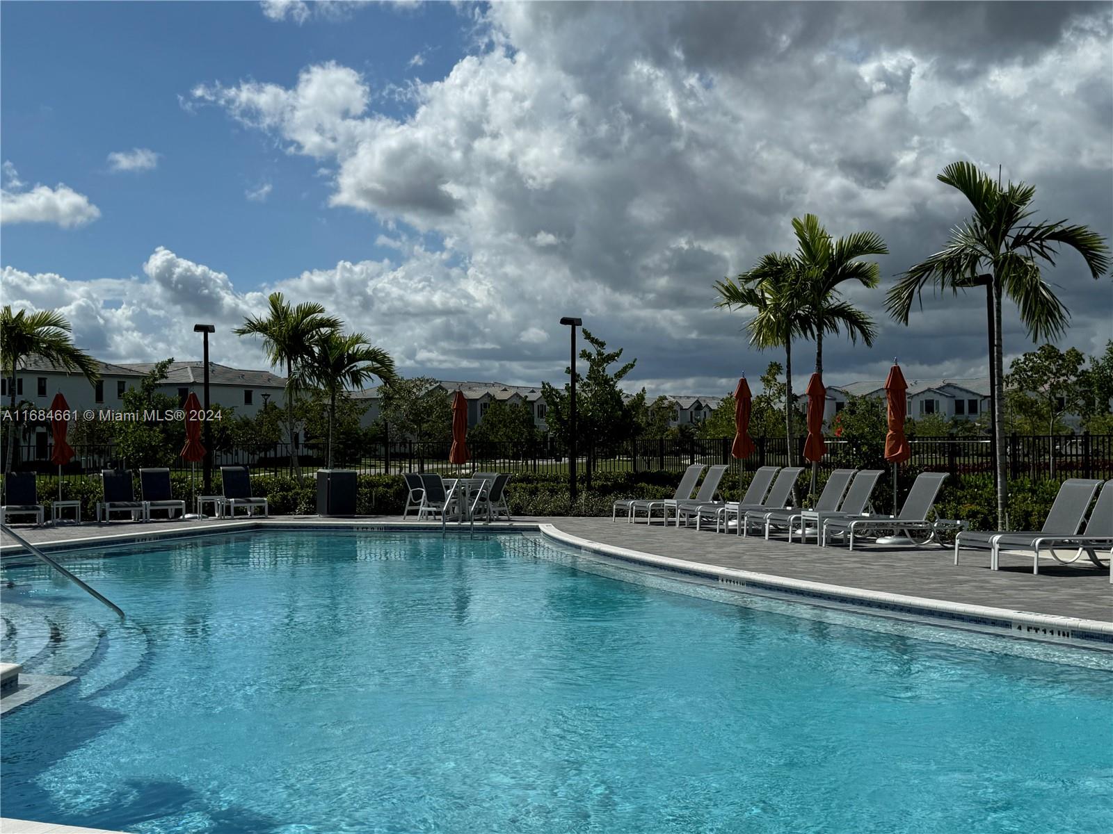 a view of a swimming pool with a table and chairs