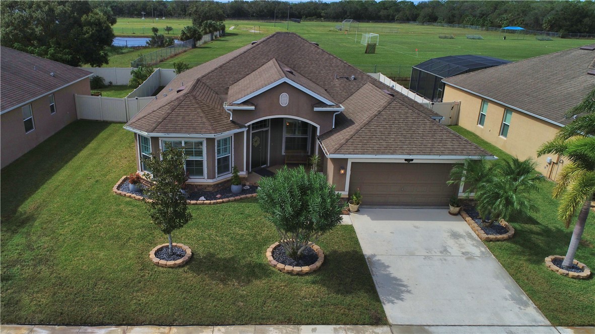 an aerial view of a house with garden space and street view