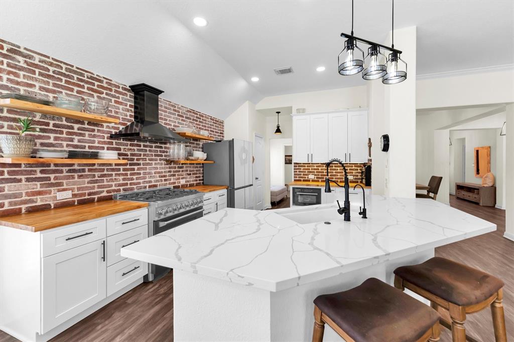 a kitchen with stainless steel appliances kitchen island granite countertop a sink and cabinets