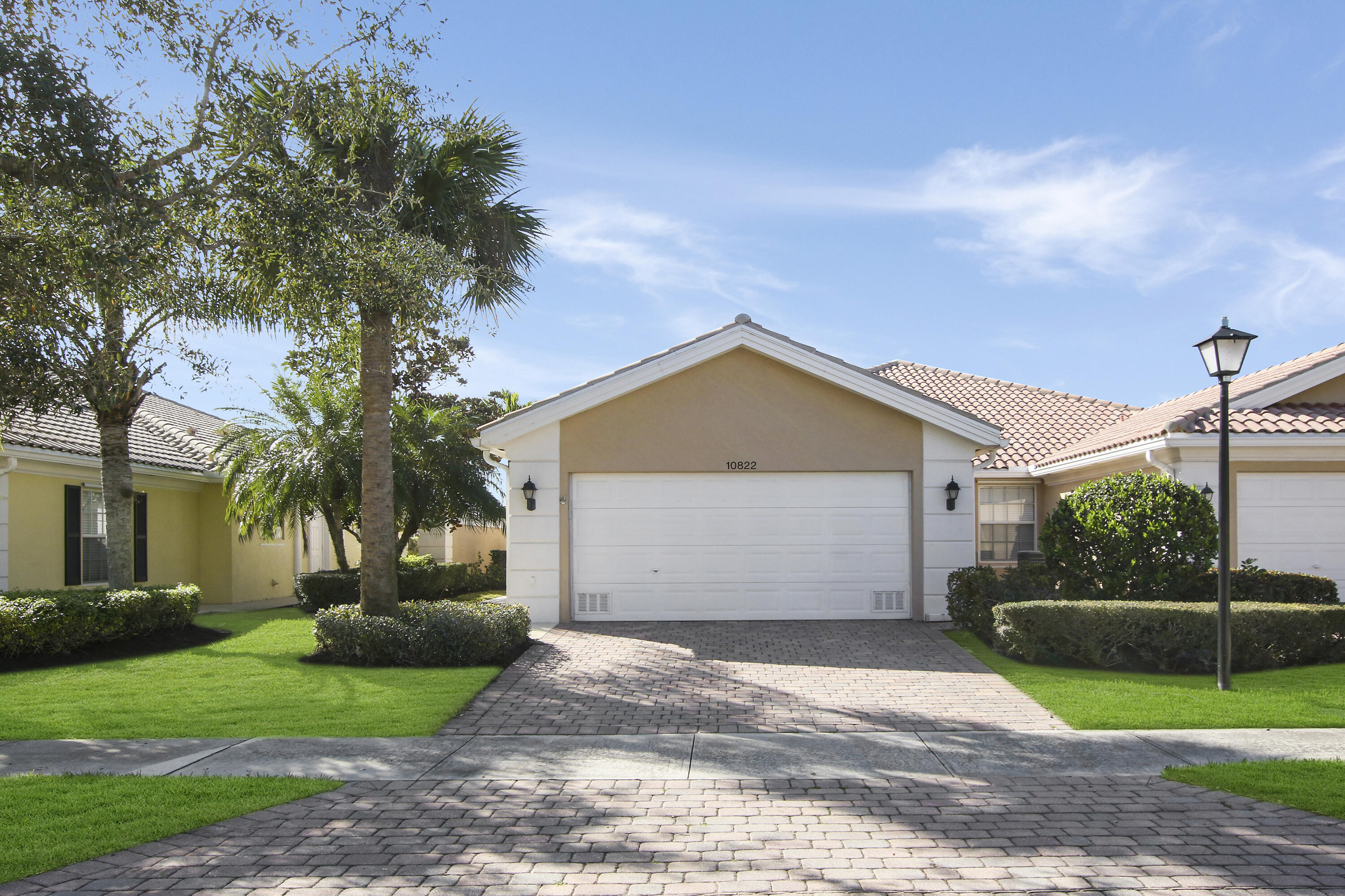 a front view of a house with a yard and a garage