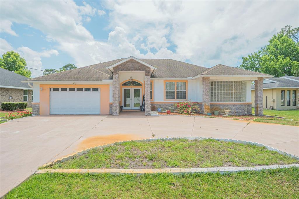 a front view of a house with a yard and garage