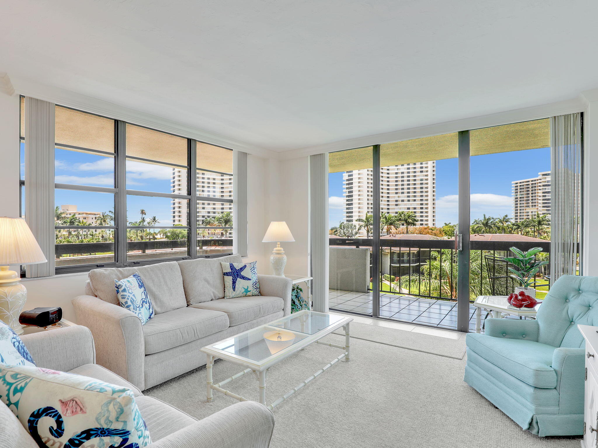 a living room with furniture and a floor to ceiling window