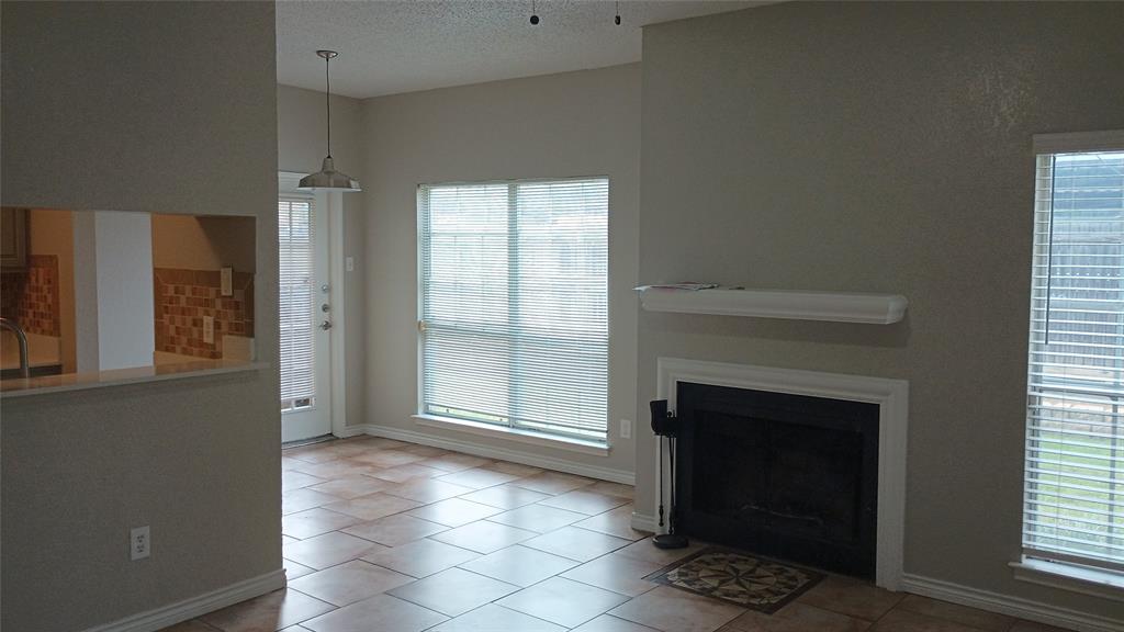 a view of a livingroom with an empty space and a fireplace