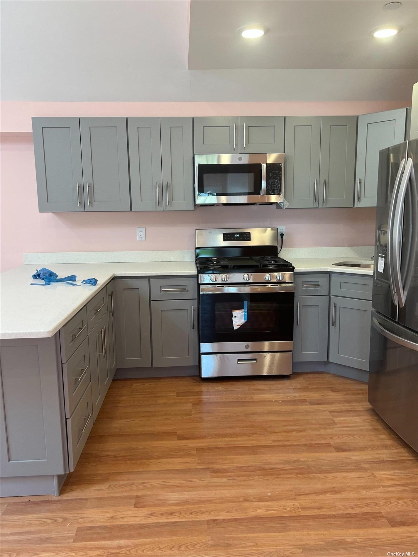 a kitchen with stainless steel appliances a stove a sink and a microwave