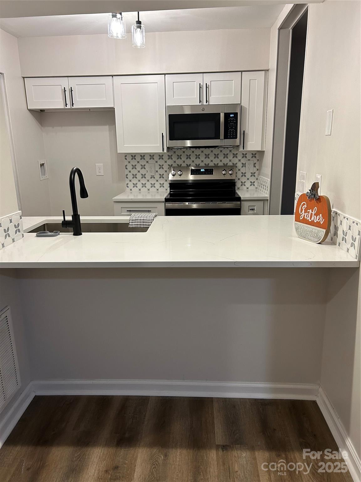 a kitchen with a sink and a refrigerator