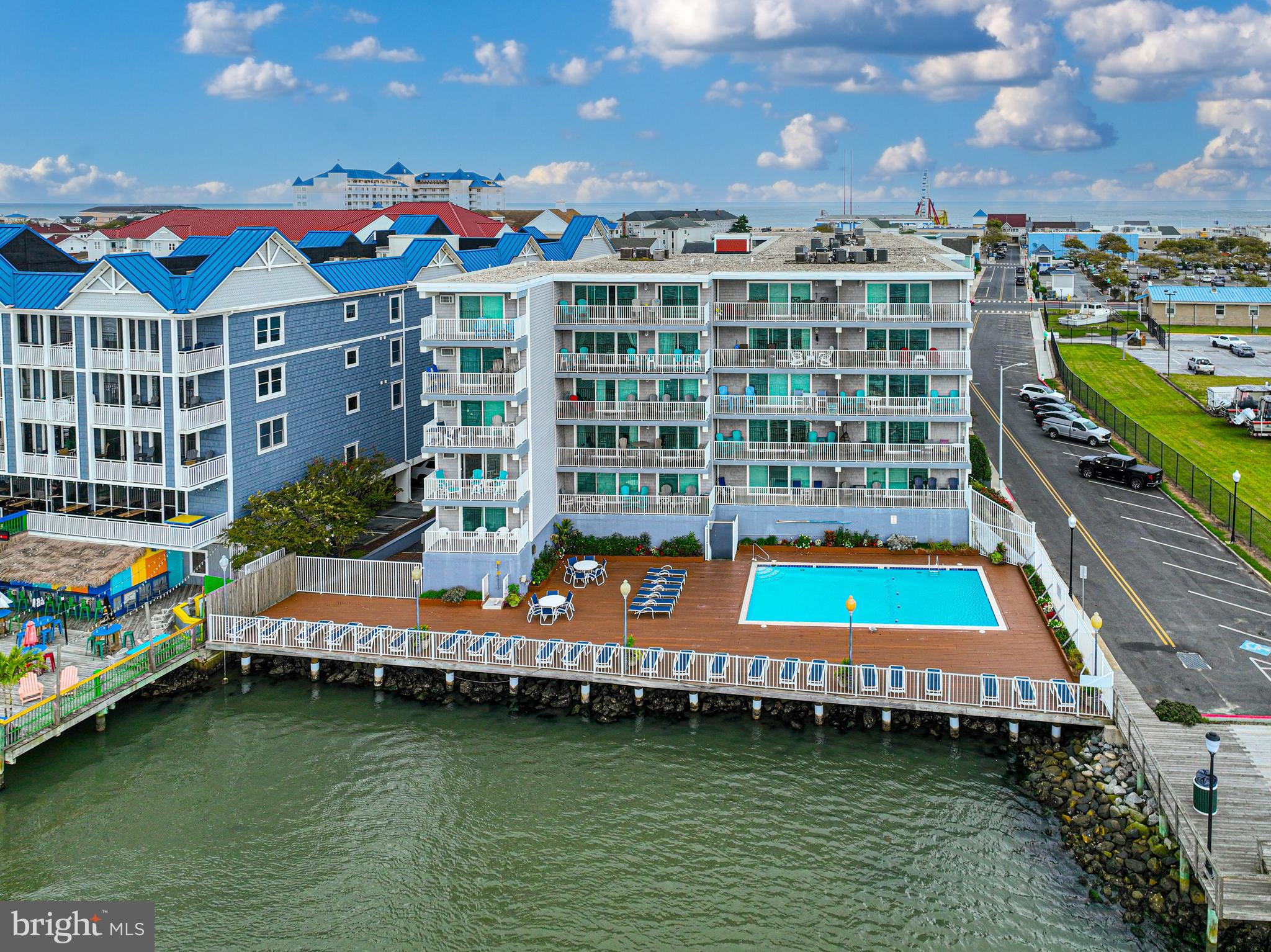 a multi story building view with swimming pool and seating space