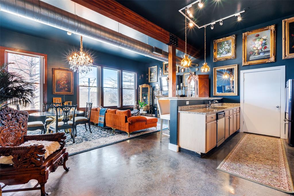 a lobby with furniture and chandelier