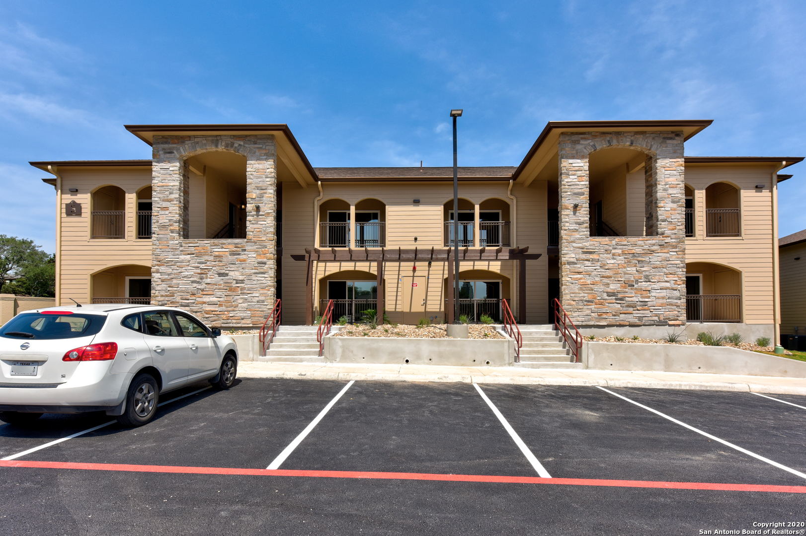 a view of a car park in front of house