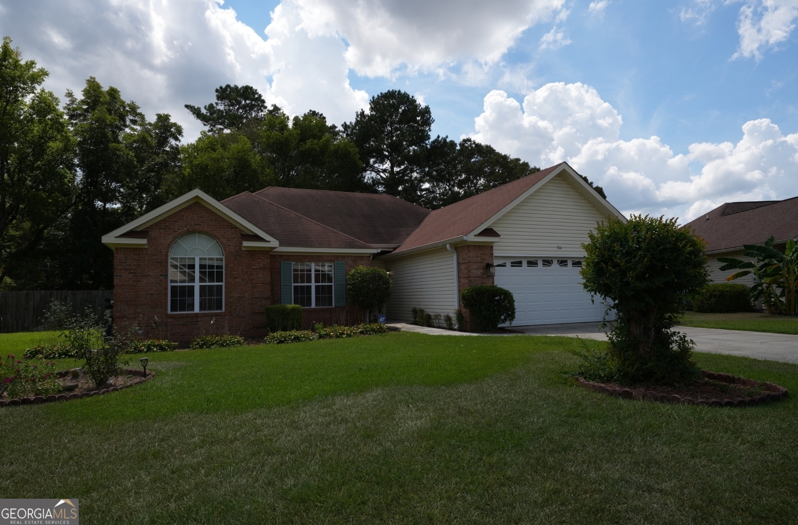 a front view of a house with garden