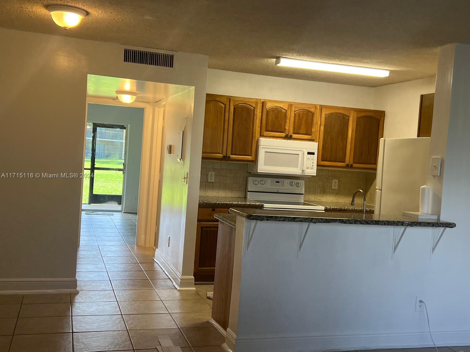 a kitchen with stainless steel appliances a sink and a refrigerator