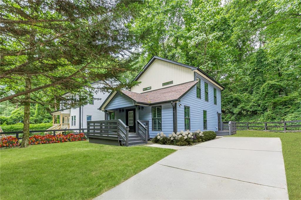 a front view of house with yard and green space