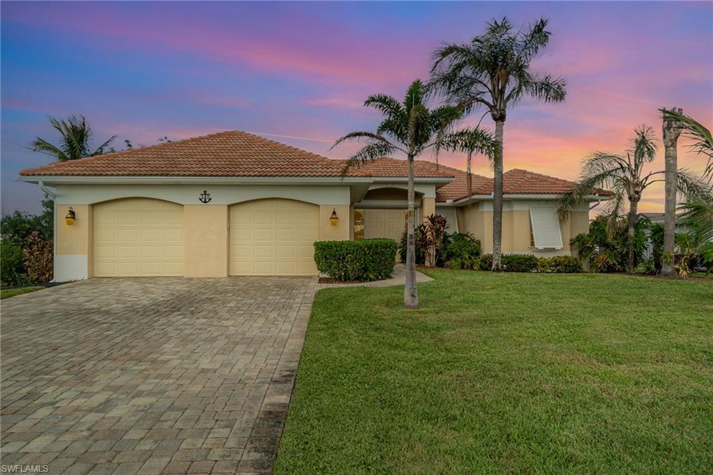 a front view of a house with a yard and garage