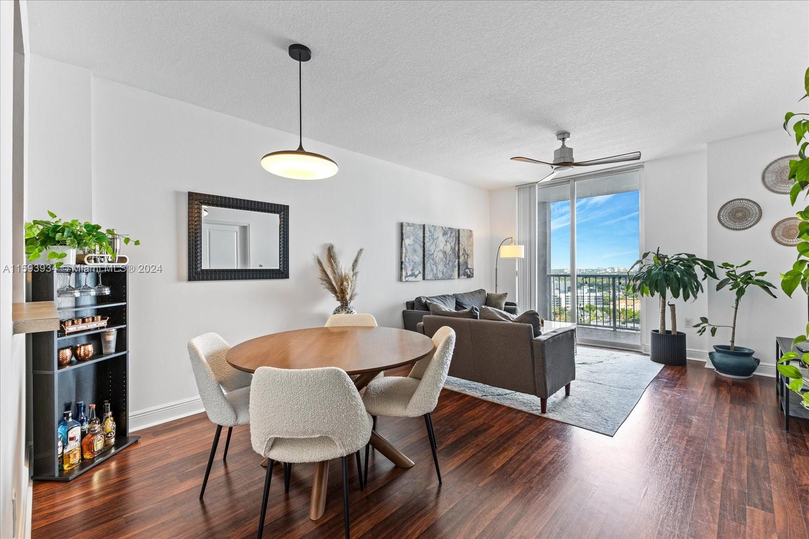 a dining room with furniture a window and wooden floor